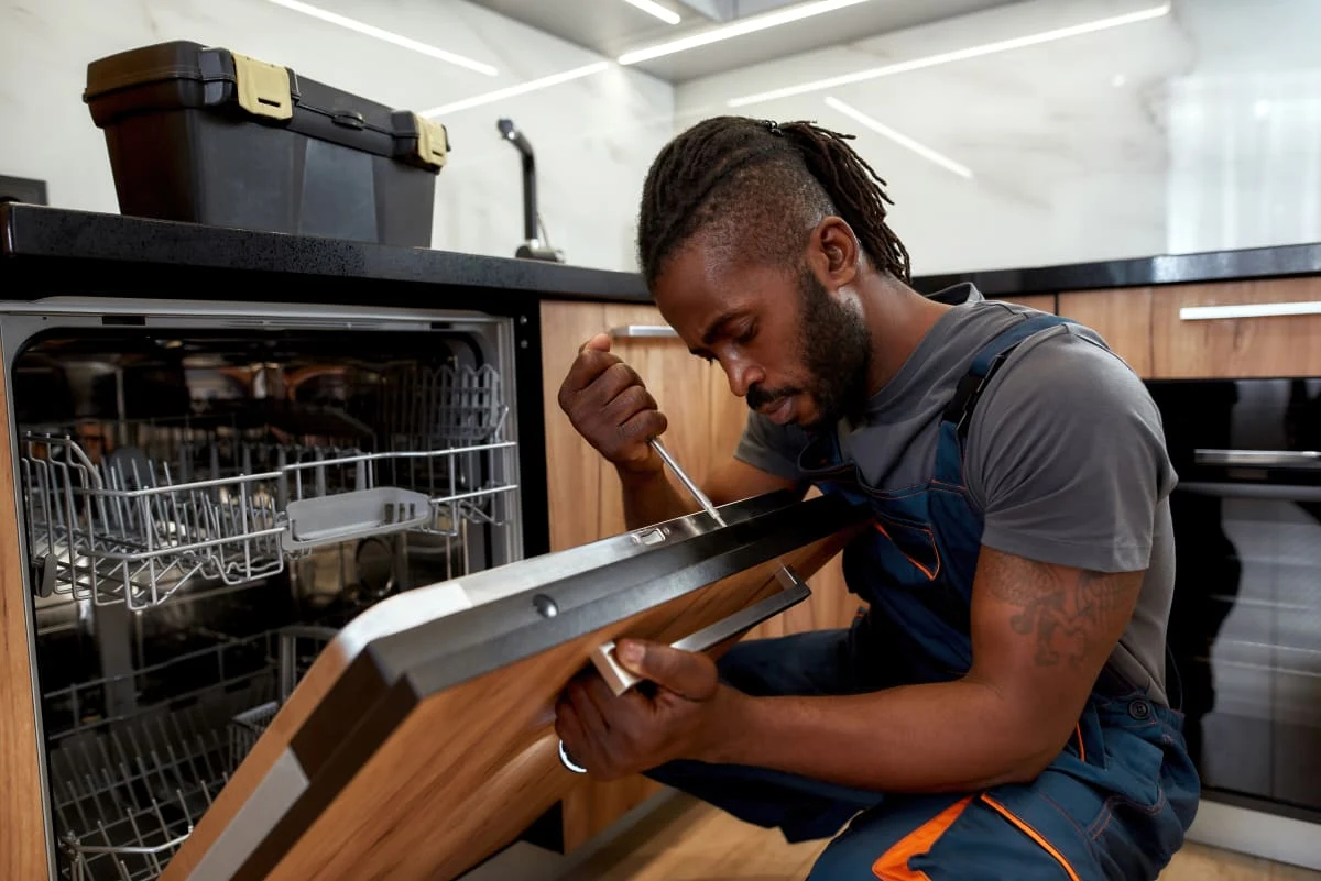 HomeHalo technician repairing a dishwasher in a customer kitchen in West Michigan