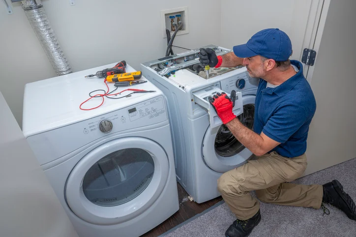HomeHalo technician repairing a washer and dryer in a customer home in Grand Rapids and West Michigan